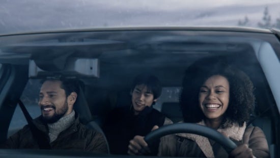 Three passengers riding in a vehicle and smiling | Andy Mohr Avon Nissan in Avon IN