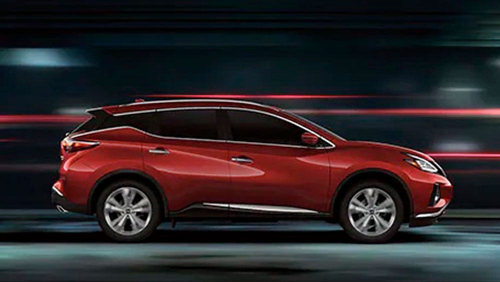 2023 Nissan Murano shown in profile driving down a street at night illustrating performance. | Andy Mohr Avon Nissan in Avon IN