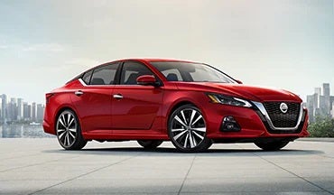 2023 Nissan Altima in red with city in background illustrating last year's 2022 model in Andy Mohr Avon Nissan in Avon IN